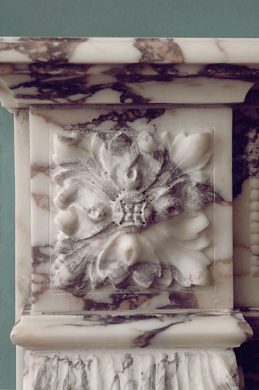 rosette carved detail in fireplace