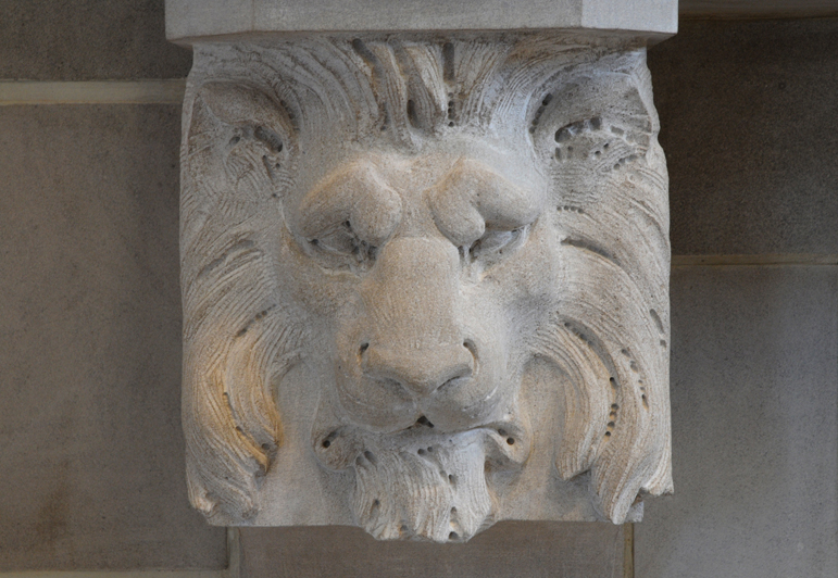 lion sculpted on fireplace mantel