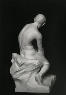 sculpture of seated boy back view